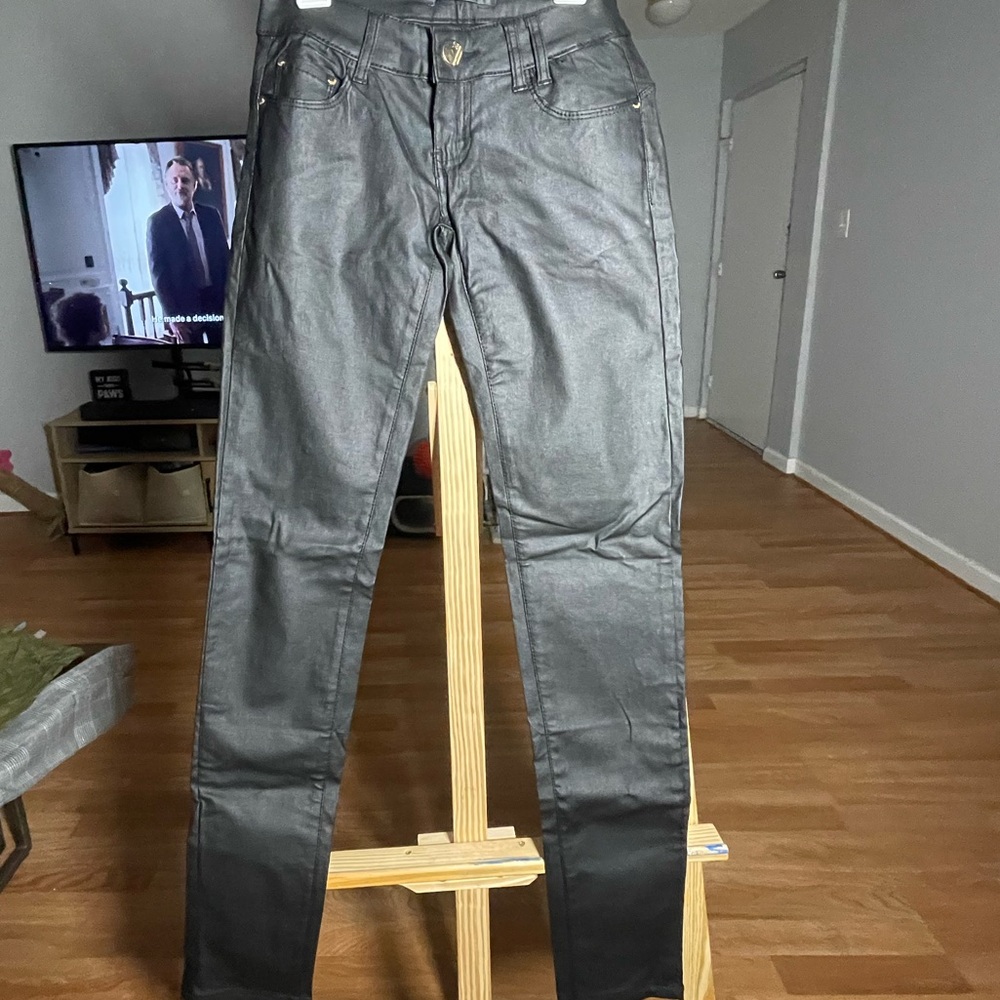 Black wax low-rise skinny pants with gold accents